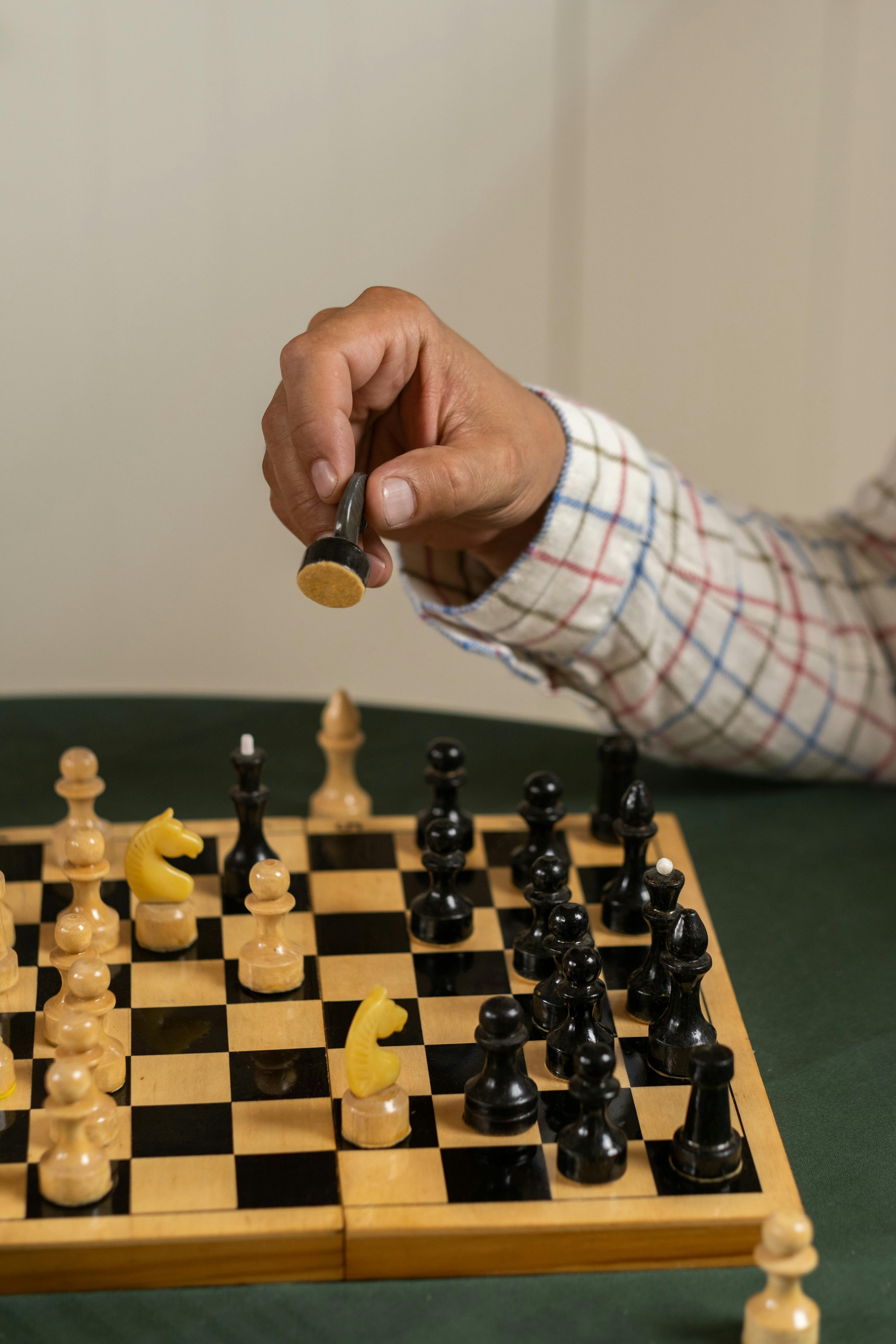 Hand Of A Man Taking A Chess Piece To Make The Next Move In A Chess Game.  Close Up. Spring Day Outside. Stock Photo, Picture and Royalty Free Image.  Image 198493640.