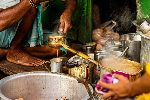 Free A vibrant scene capturing traditional chai preparation in an urban market setting. Stock Photo