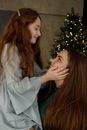 Redhead Teenage Girl Smiling and Touching Face of Her Big Sister