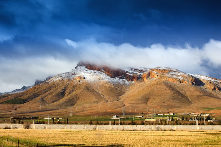 Clouds Over Mountain And Village