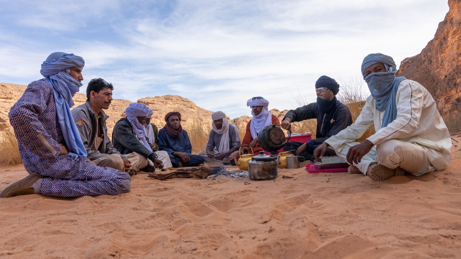 Group of people sitting on sand, Mali