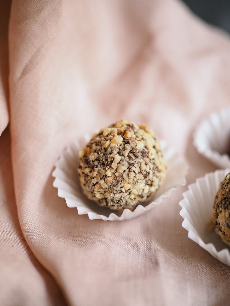 Close-up Of Chocolate Truffles On Pink Fabric