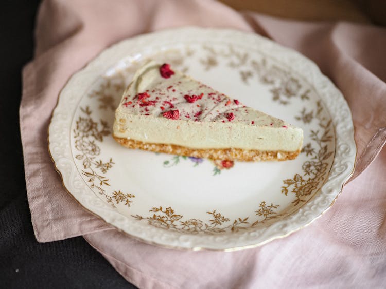 Piece Of Cheesecake On Vintage Ornamental Plate