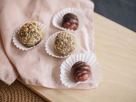Sweet Balls in Cupcake Paper Cups on Pink Serviette