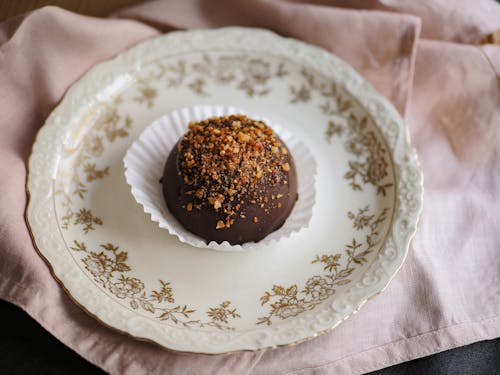 Chocolate Ball in Cupcake Paper Cup Served on Vintage Plate