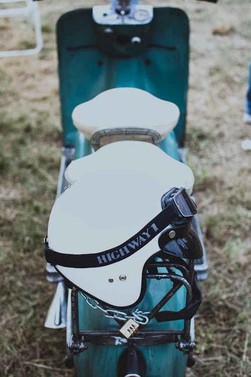 White and Black Backpack on Green Wooden Bench