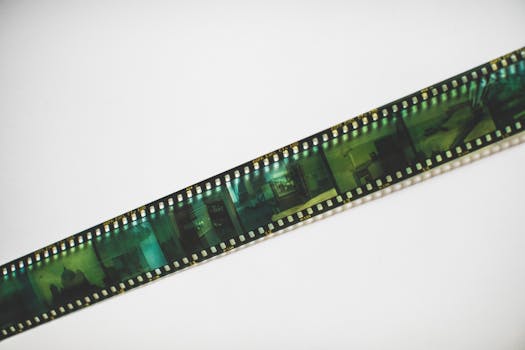 Close-up of a vintage film strip on a white surface, evoking nostalgia and retro vibes.