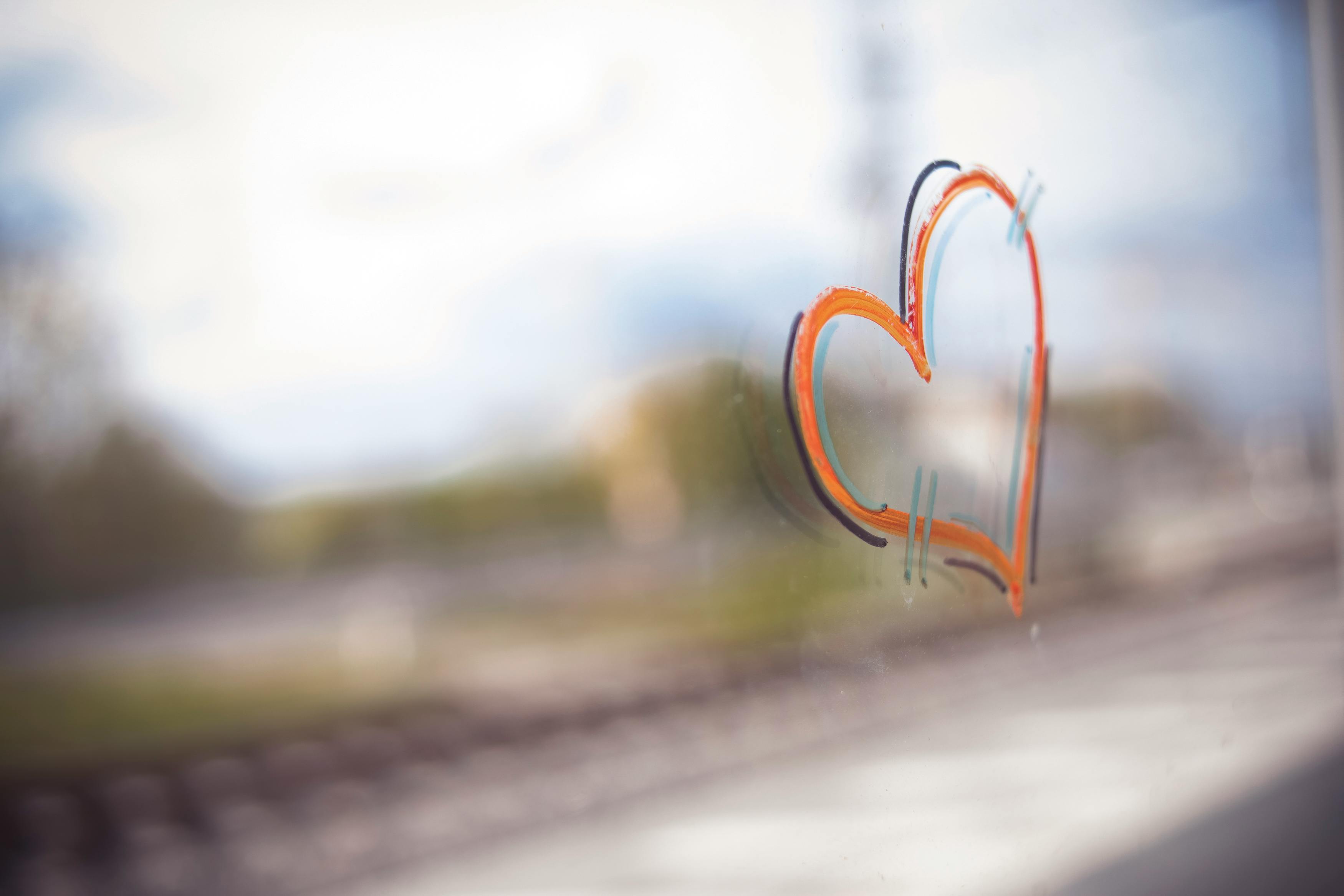 a drawing of a heart on a window glass