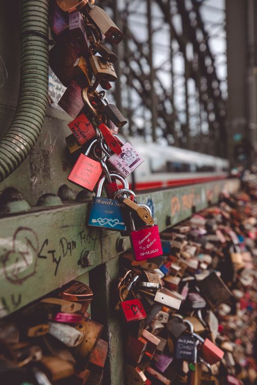 Free Vibrant love padlocks attached to a bridge fence symbolizing eternal love and commitment. Stock Photo