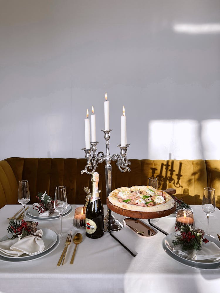 Lighted Candles On A Silver Candle Holder On Table