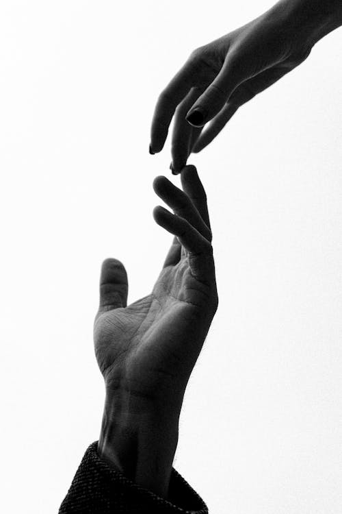 Free Grayscale Photo of Two People Touching Fingers Stock Photo