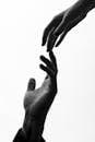 Male and Female Hands Nearly Touching Each Other