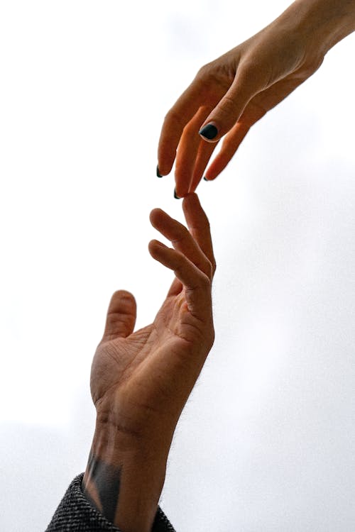 Free Two People Touching Hands Stock Photo
