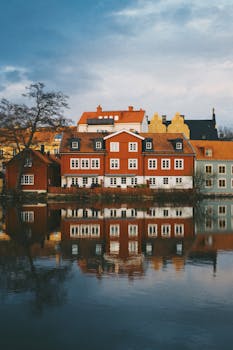 Colorful Scandinavian houses reflecting in the river in Uppsala, Sweden.