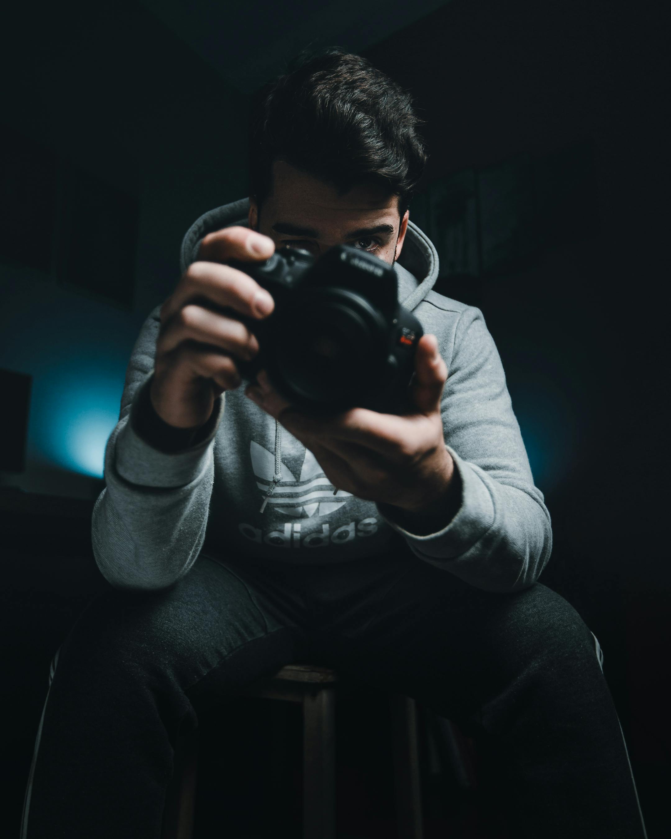 Photo of Man Standing in Alley Holding Dslr Camera Looking at Photos ...