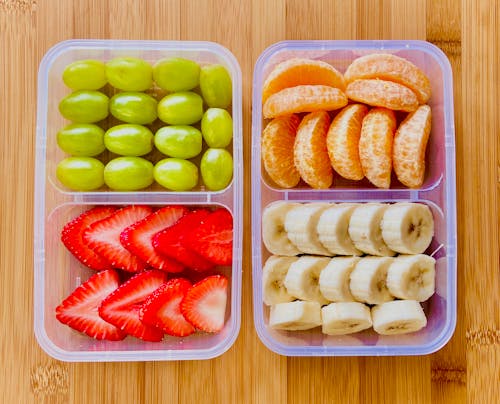 Sliced Fruits on Two Plastic Containers