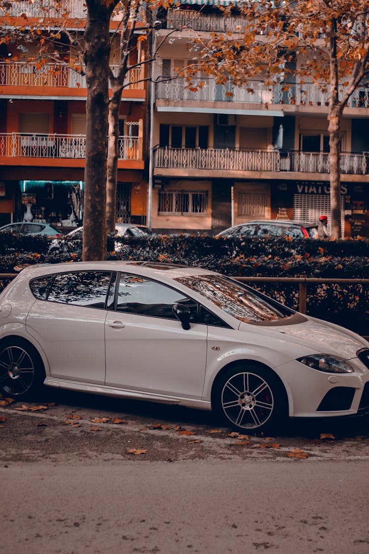 White Sedan Parked On Sidewalk