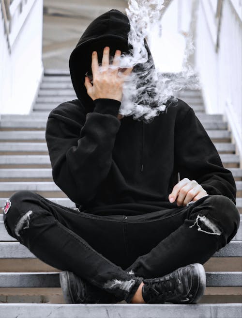 Man in Black Jacket Smoking Cigarette