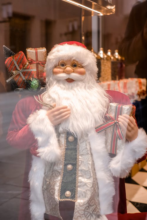 Santa Claus Holding Red and Gold Gift Box