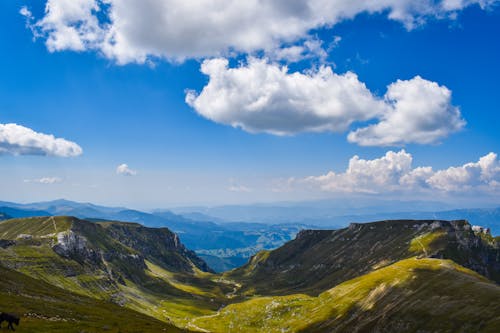 Green Mountains Under Blue Sky and White Clouds