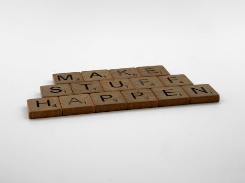 Close-Up Shot of Scrabble Tiles on White Background