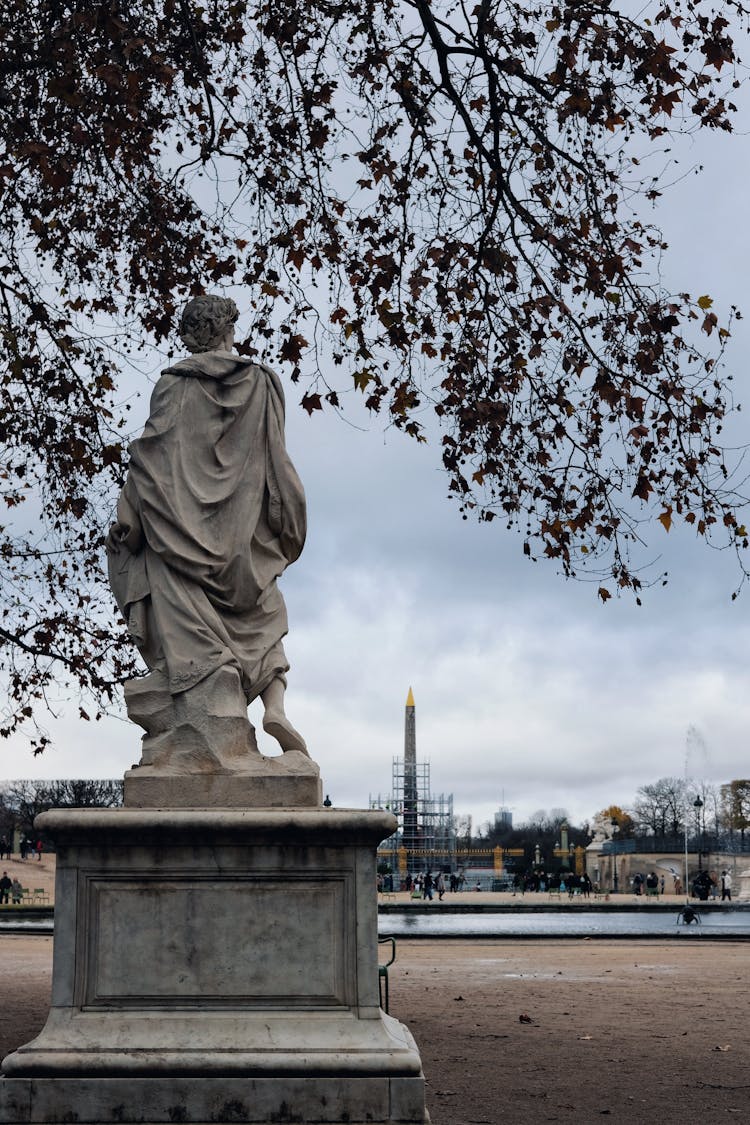 A Statue Near The Luxor Obelisk In Paris