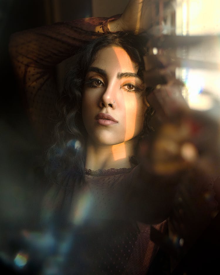 Blurred Portrait Of Woman With Sunlight Reflecting On Her Face