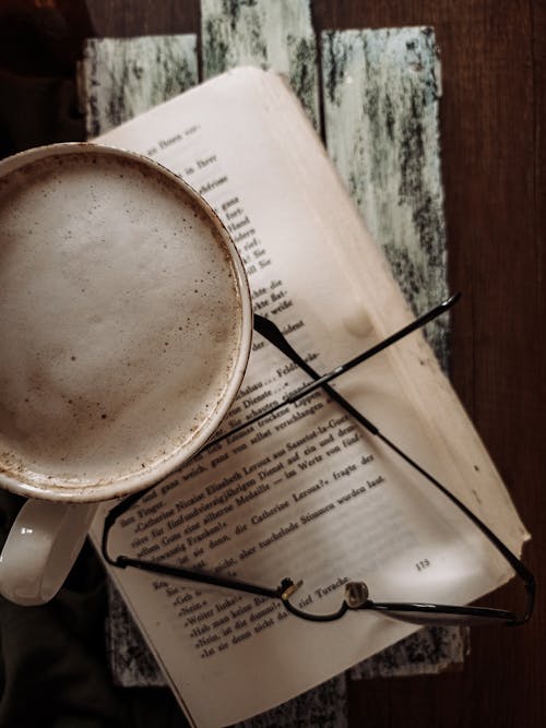 Free A Cup of Coffee on Top of a Book Stock Photo
