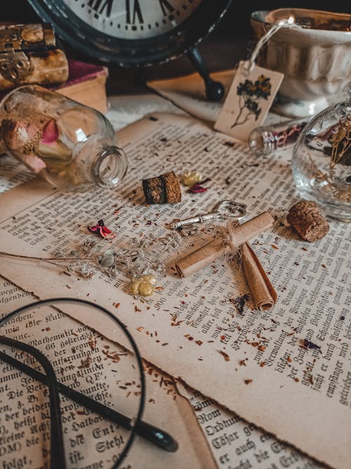 Clear Bottle and Corks on Top of Old Papers 