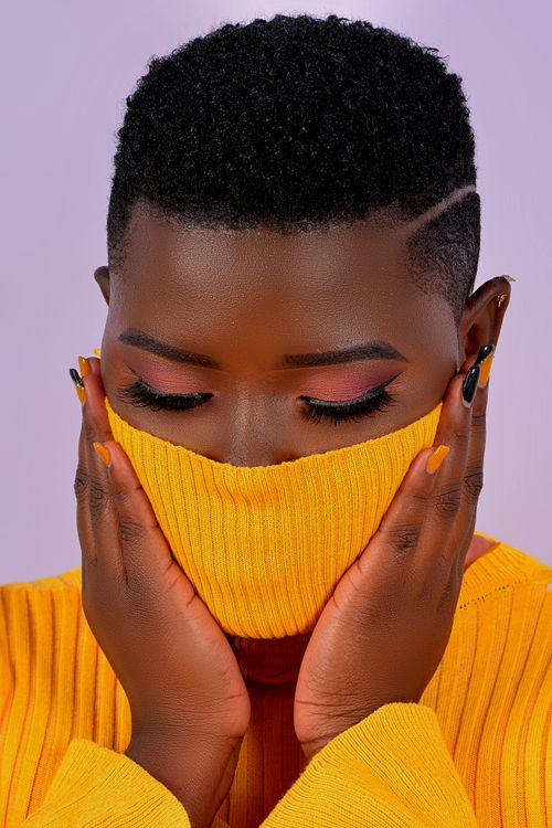 Free Close-up portrait of a woman in a vibrant yellow turtleneck with a fashionable hairstyle. Stock Photo