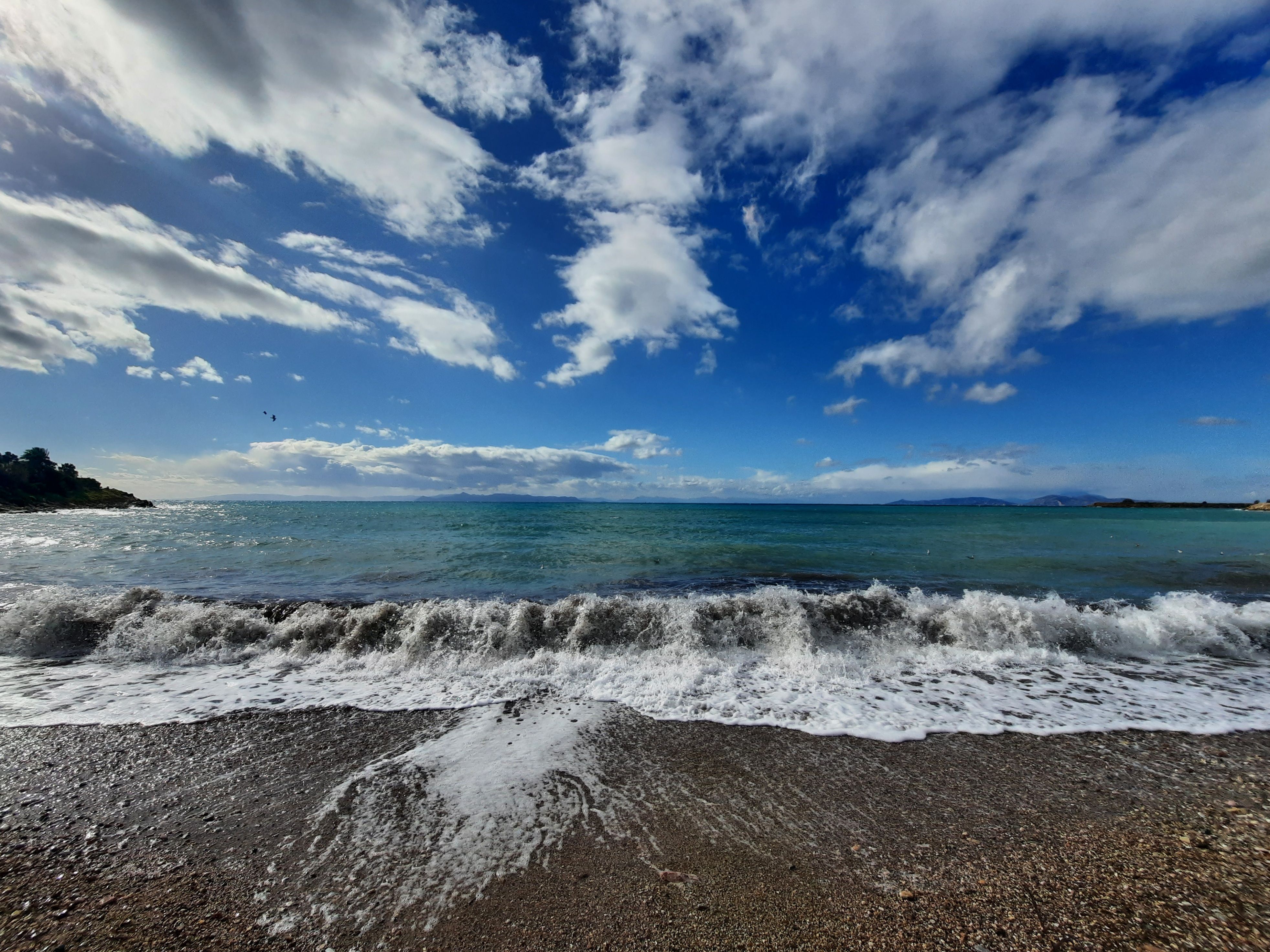 Ocean Waves Crashing on Shore Under Blue Sky and White Clouds · Free ...