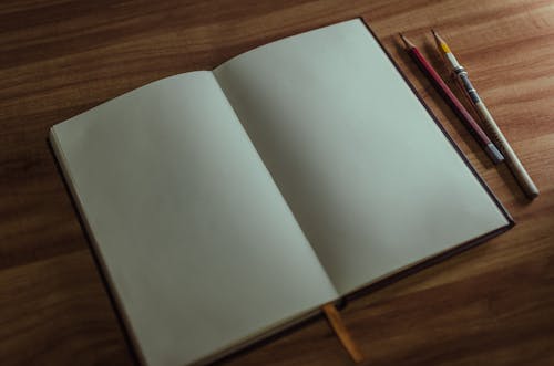 Free Blank Notebook on a Table Stock Photo
