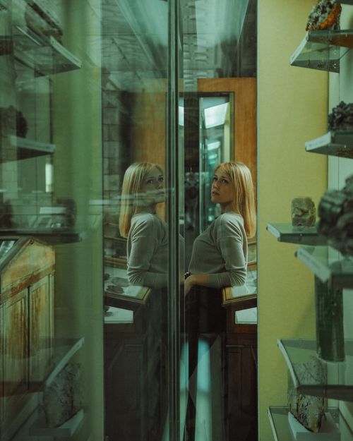 Free Caucasian woman reflected in a museum glass exhibit in England. Stock Photo