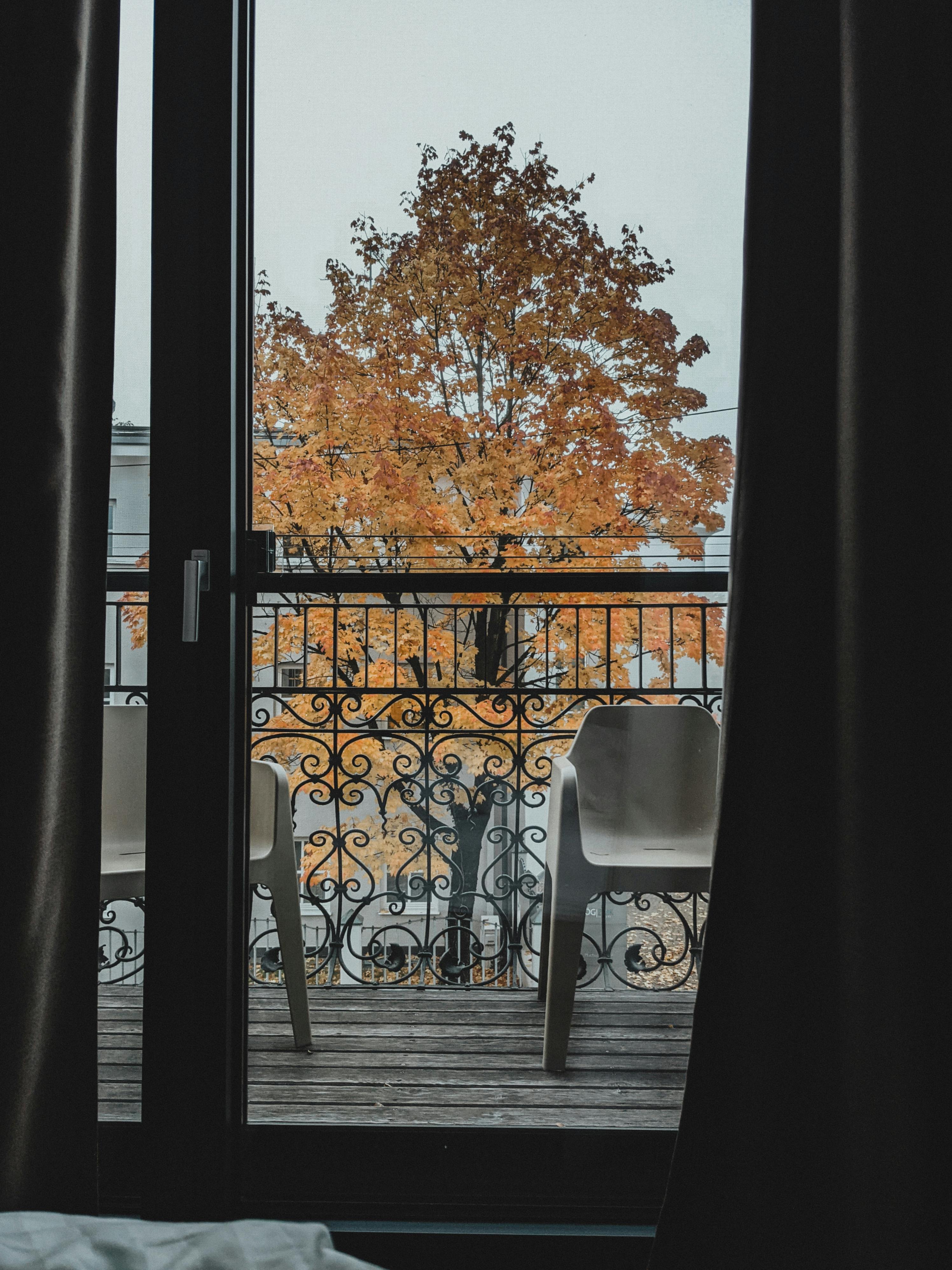 Two White Chairs on Balcony with Black Metal Railing · Free Stock Photo