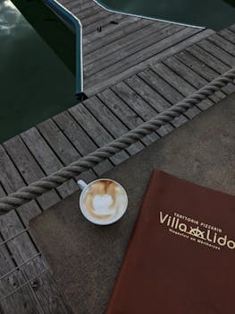 Cappuccino served on a rustic dockside at Villa Lido, Klagenfurt, Austria.