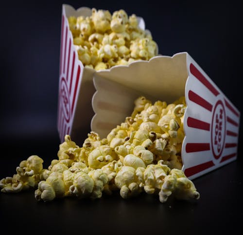 Popcorn Spilled from a White and Red Striped Tumbler