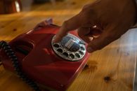 Close-up of Mans Hand Dialing on Rotary Phone