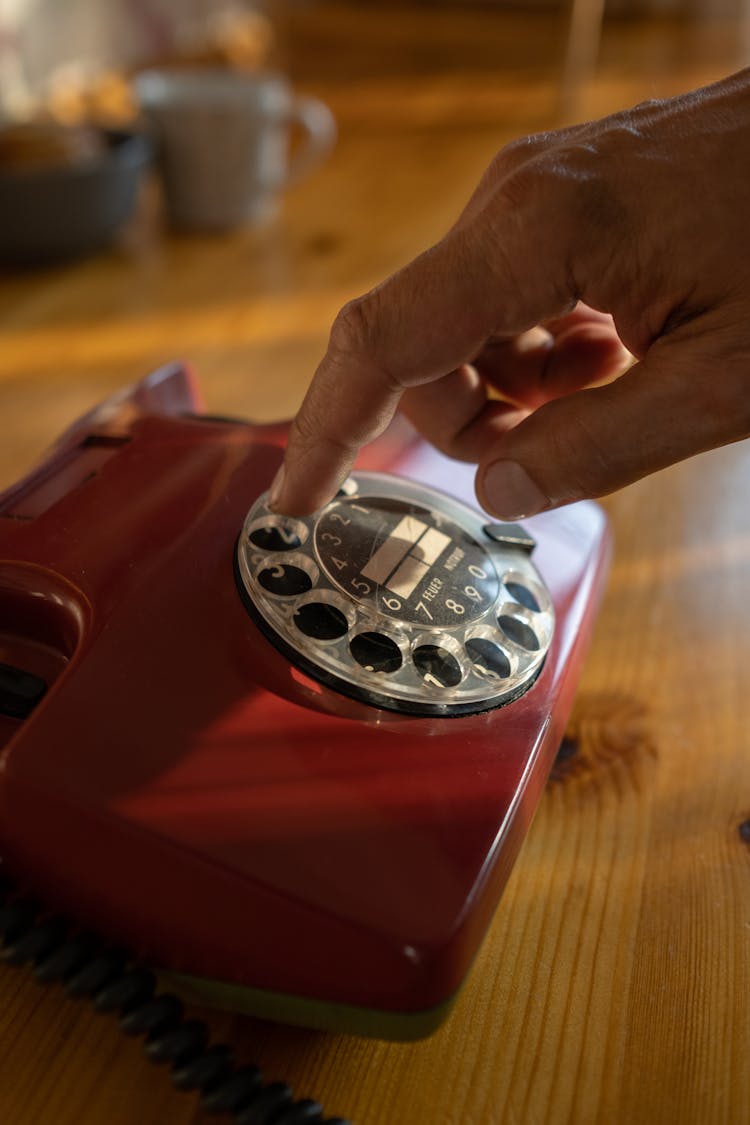 Close-up of Mans Hand Dialing On Rotary Phone