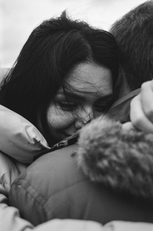 Black and White Portrait of Woman Hugging Man