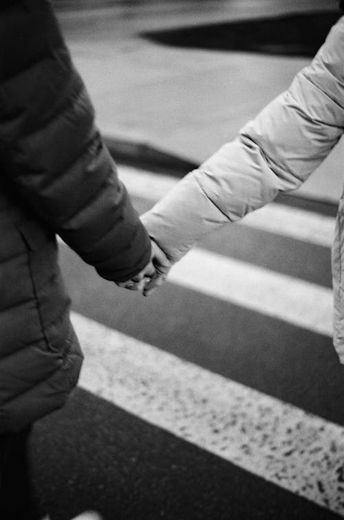 Free Grayscale Photo of a Couple Holding Hands Stock Photo