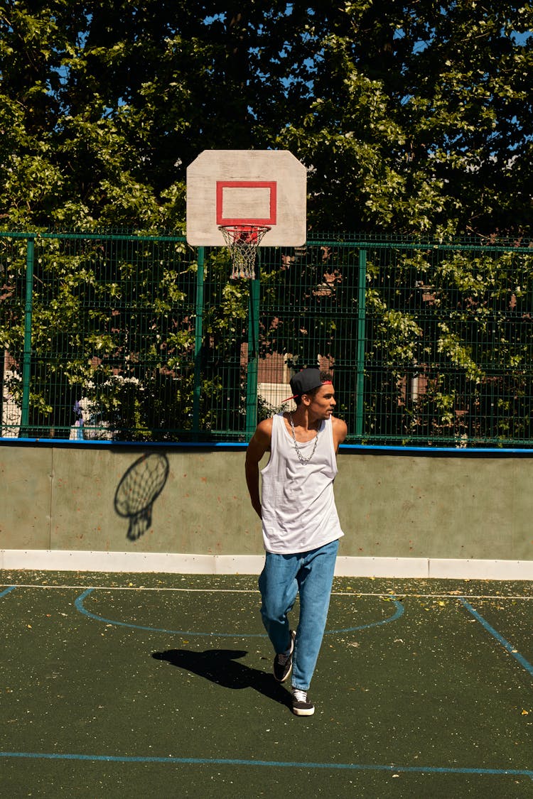 A Man Walking On The Basketball Court