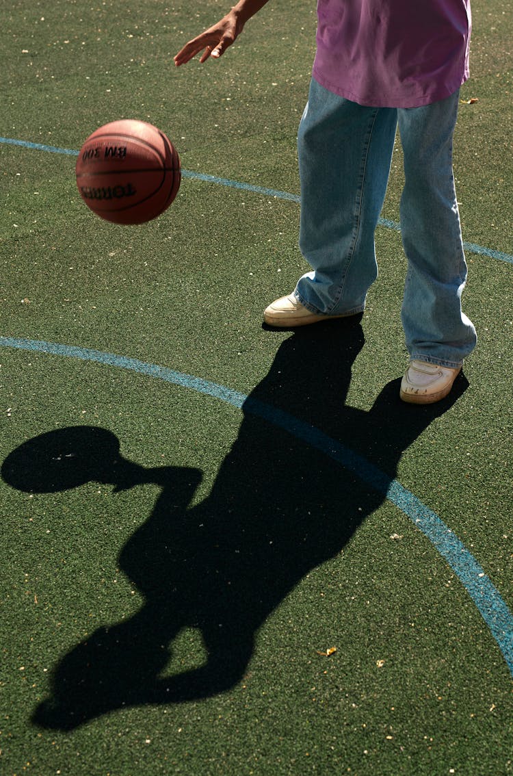 A Person Dribbling A Ball