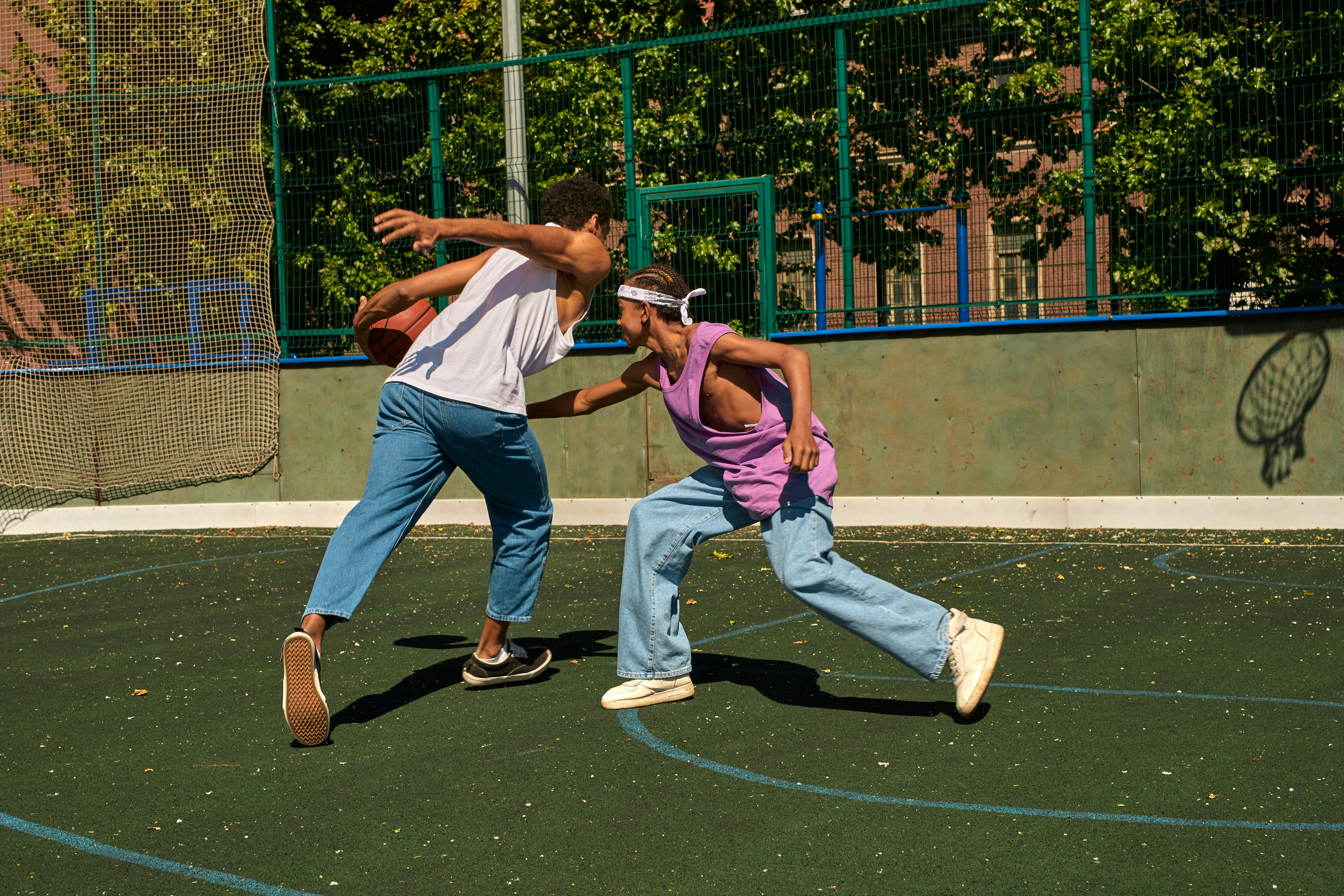 two men playing a basketball