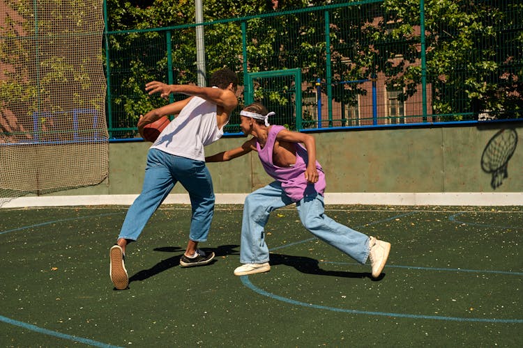 Two Men Playing A Basketball