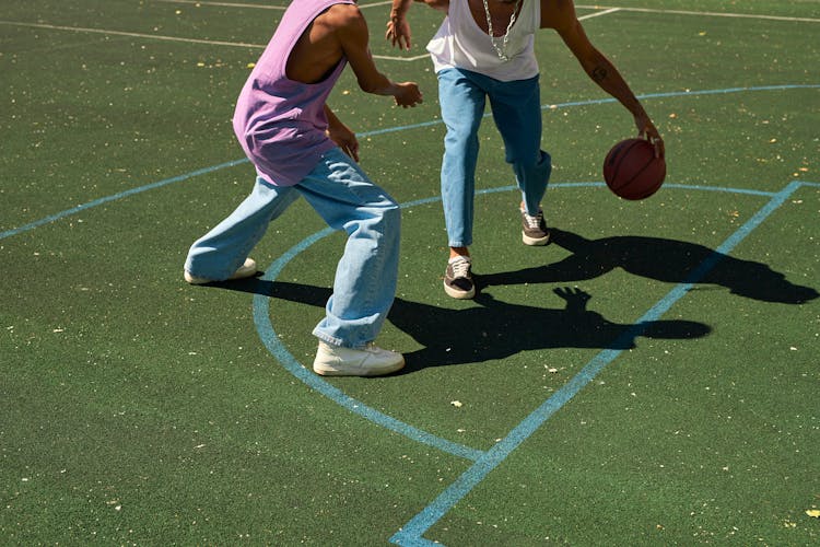 Two Men Playing A Basketball