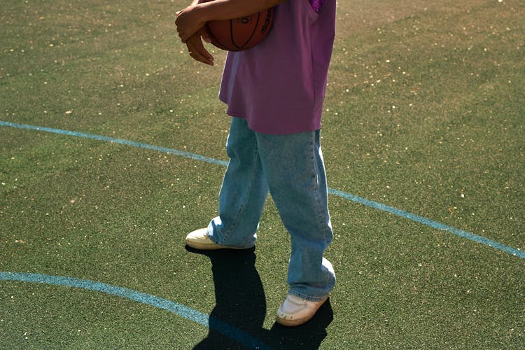 A Person Holding A Ball