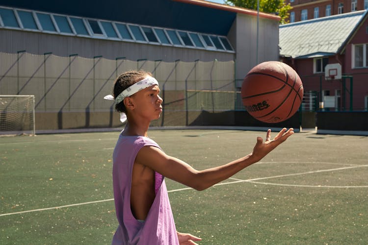 A Boy Tossing A Ball