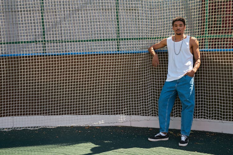 Young Man Posing In Front Of A Net