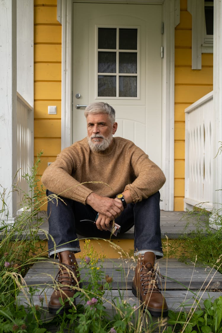 Elderly Man Sitting On Porch