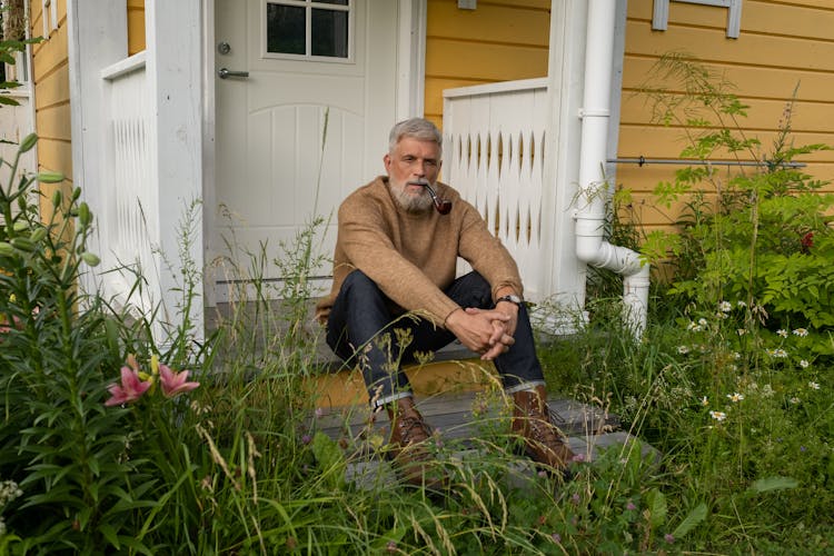 Elderly Man Sitting On Porch